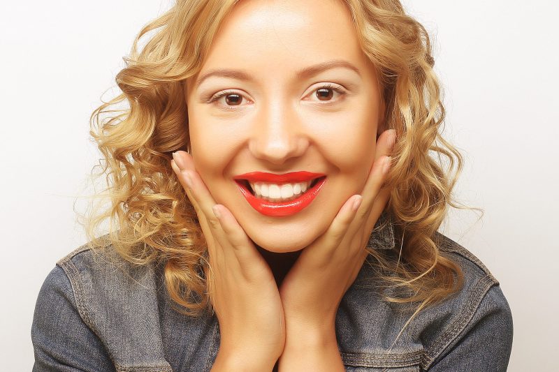 Beautiful young surprised blond woman. Studio shot.
