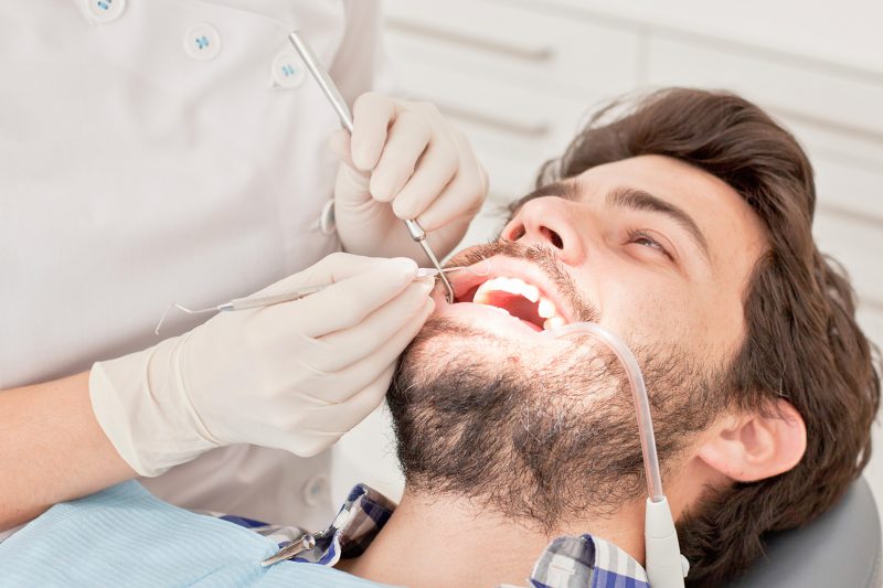 young man and woman in a dental examination at dentist